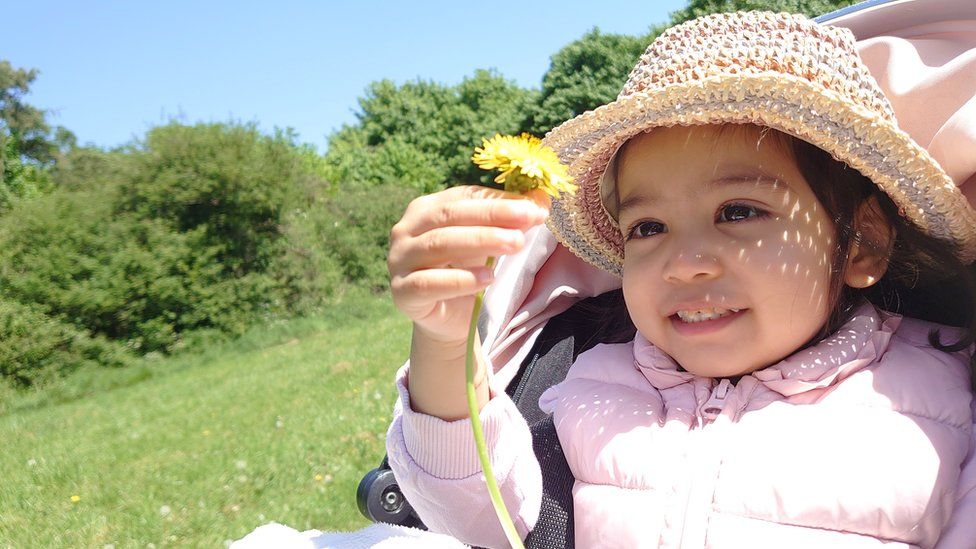 Ivy Rupasinghe holding a flower