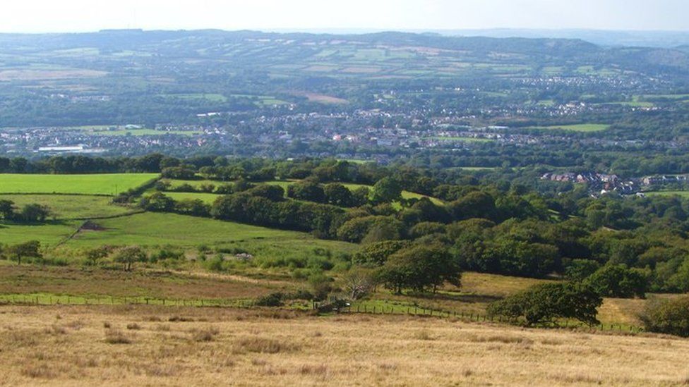Ammanford in the distance surrounded by rural hills
