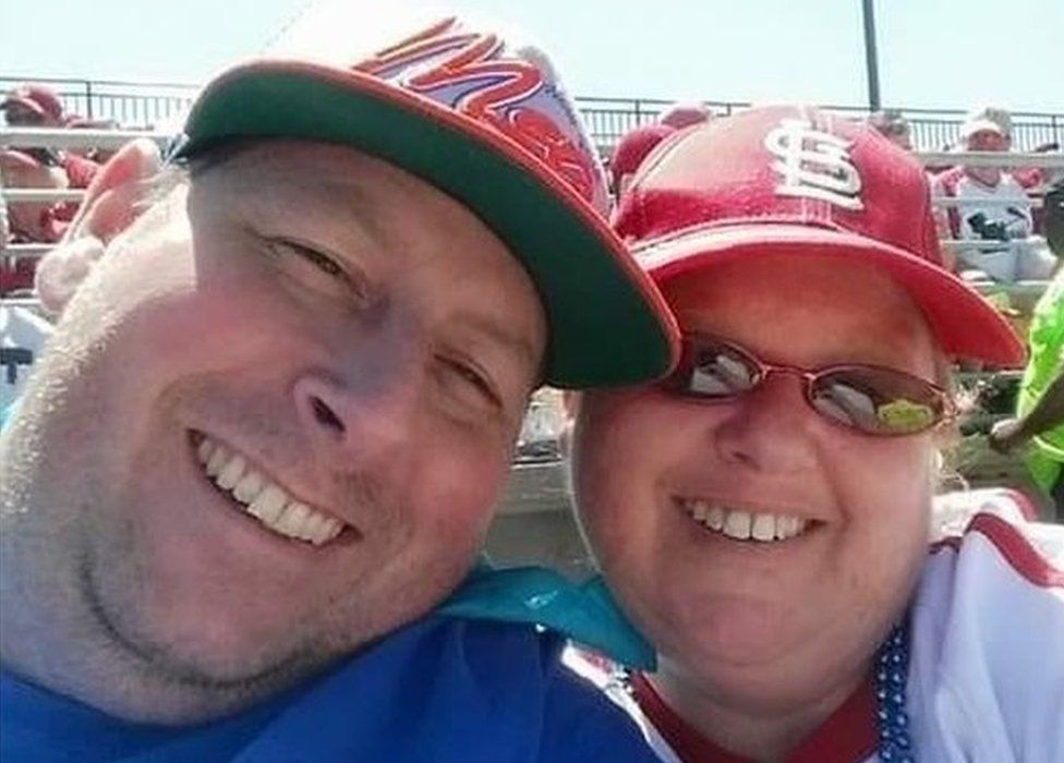Man and woman at baseball game.