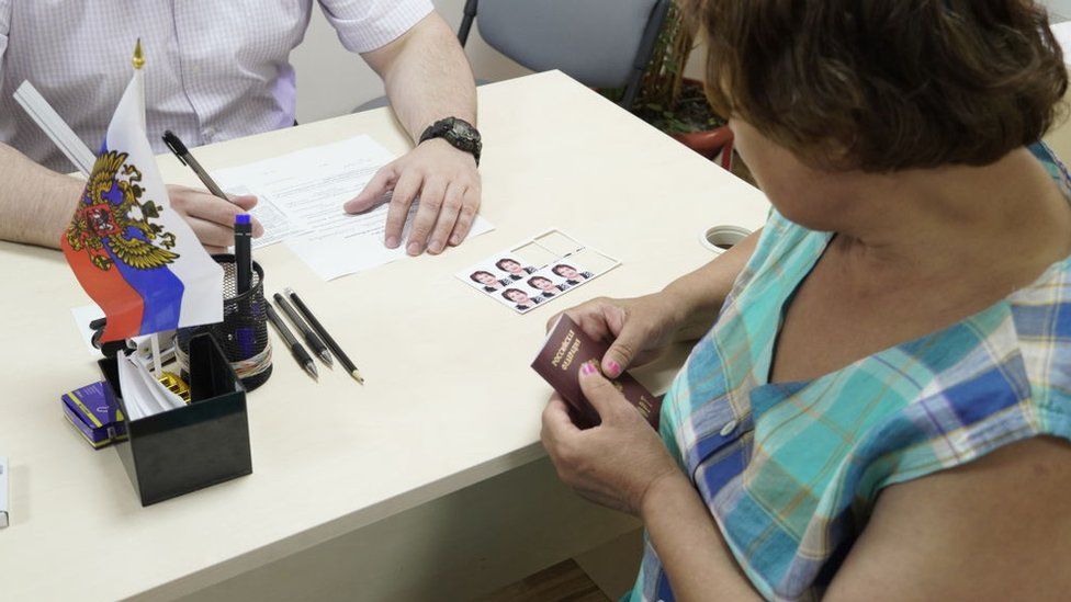 A woman applies for her new Russian passport in Kherson, 2022