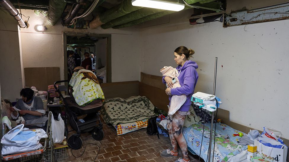 Woman with baby in underground shelter in Kyiv