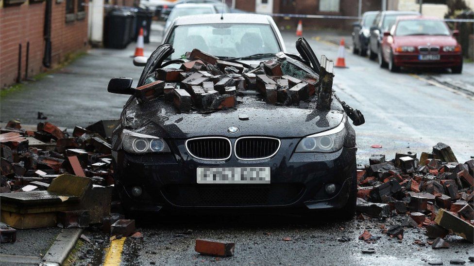 A BMW damaged by falling bricks