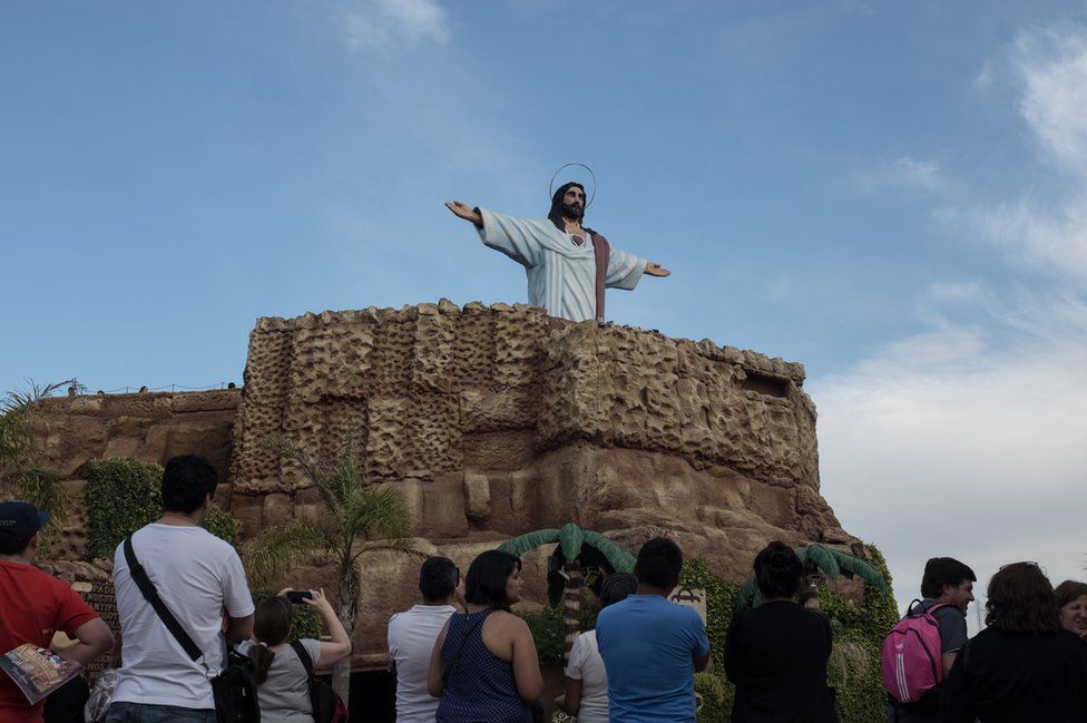Tourists watch Jesus rise