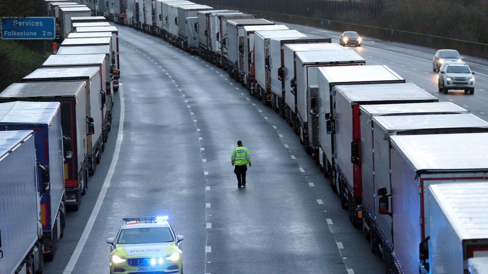 Police patrol along the M20 in Kent where freight traffic is parked up near to Folkestone services whilst the Port of Dover remains closed.
