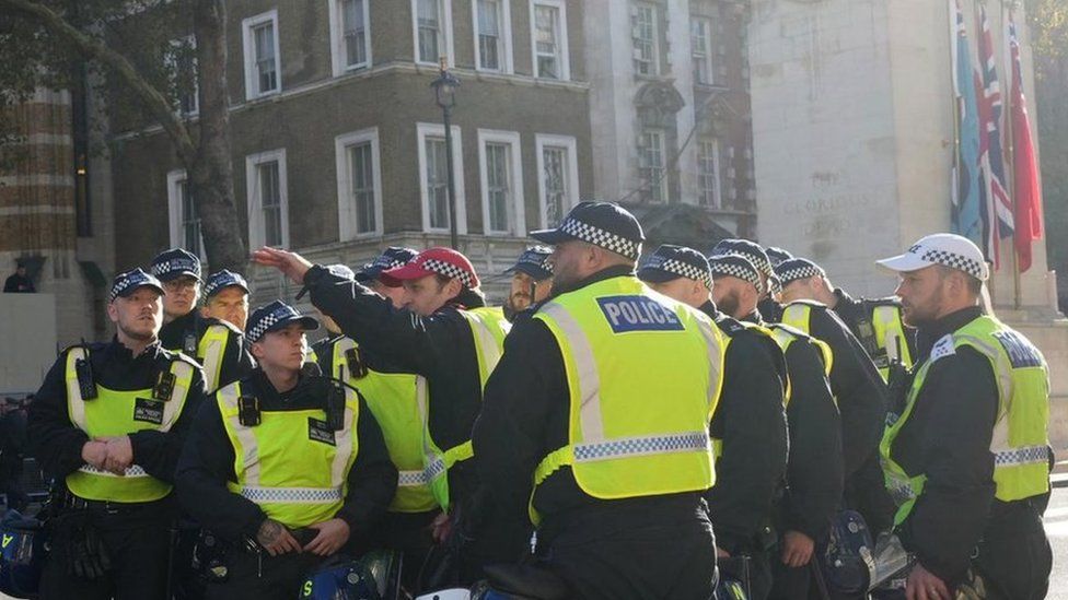 Police officers take their positions by the Cenotaph in Whitehall on Saturday morning