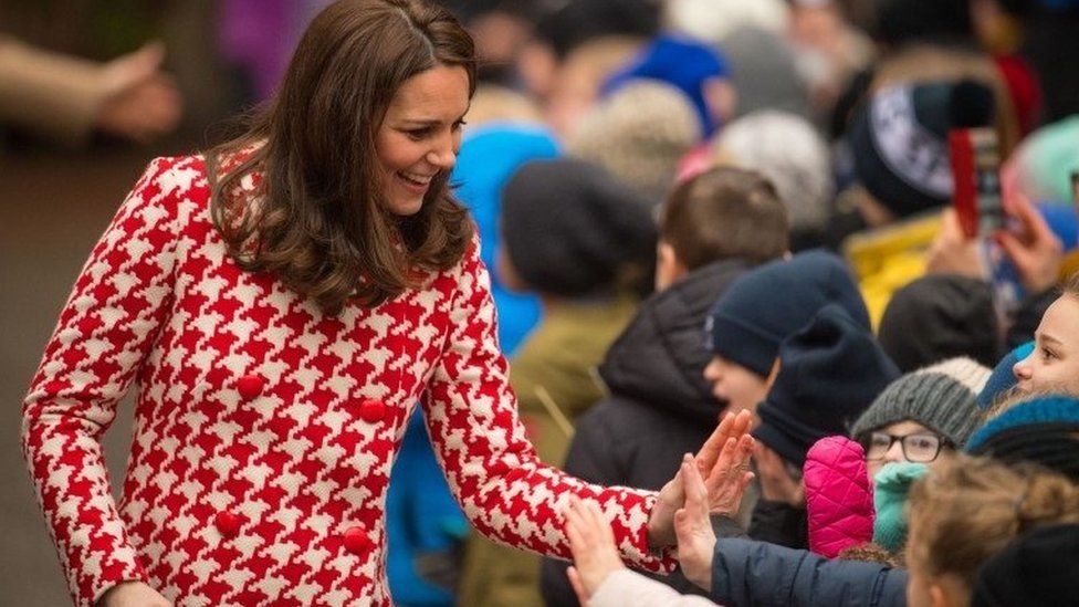 The duchess high-fives youngsters