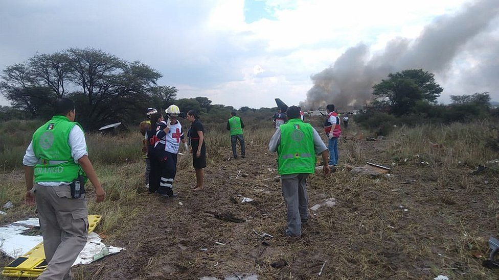 Photo of wreckage and rescue workers at the scene of crash in Mexico