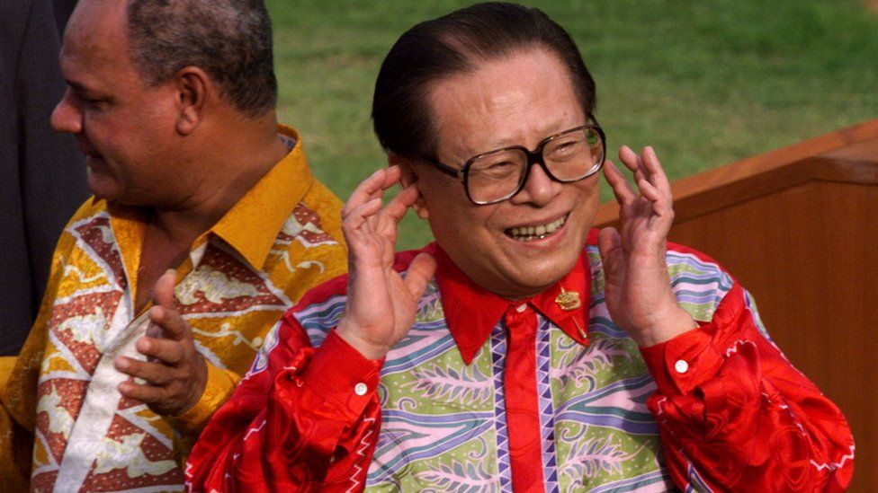 China's President Jiang Zemin puts his finger in his ear in response to yelling from the media after the Asia Pacific Economic Cooperation (APEC) leaders' declaration at the end of their summit at Cyberview Lodge in Cyberjaya, Malaysia November 18, 1998.