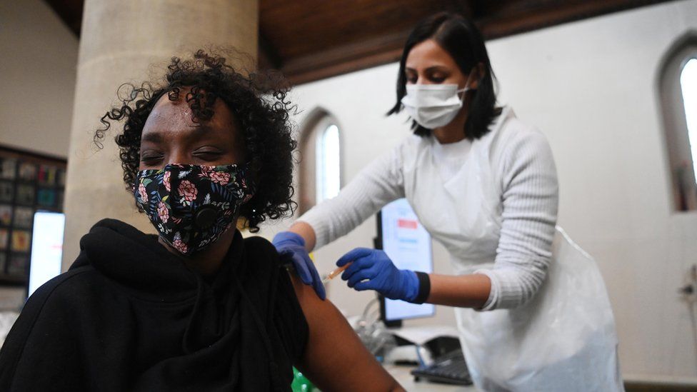Woman receiving her vaccine