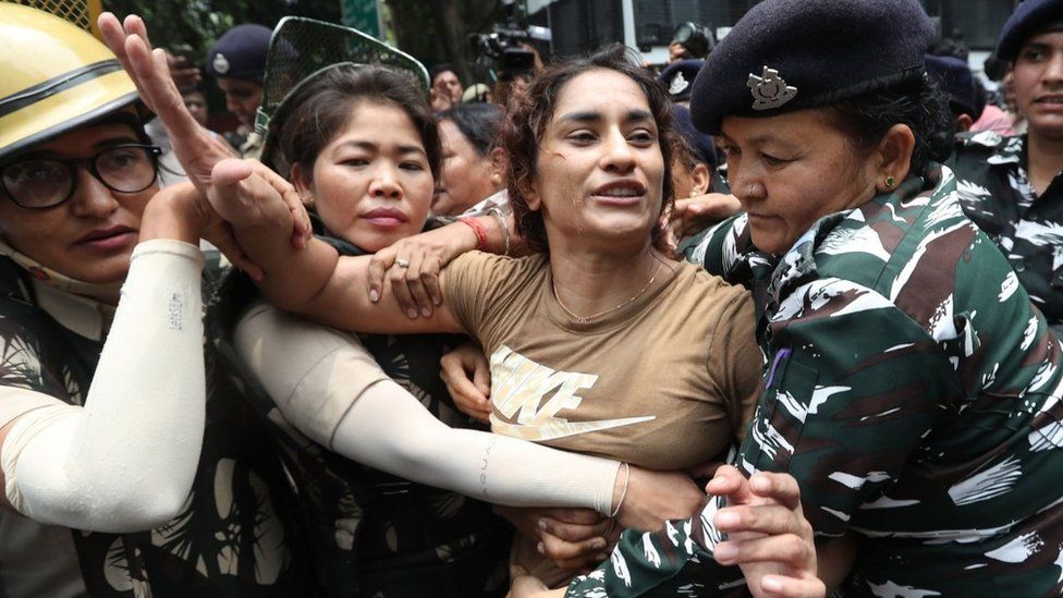 Vinesh Phogat is detained by police during a protest in New Delhi in May