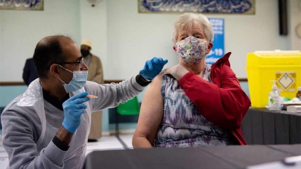 Sheila Evans receives an injection of the Oxford-AstraZeneca coronavirus vaccine at the Al Abbas Mosque, Birmingham