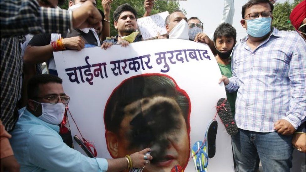 Activists of Bharatiya Janata Party"s (BJP) Youth Wing put black paint on a portrait of Chinese President Xi Jinping, with a garland of shoes put around it, during a protest against China, in Amritsar, India, 22 June 2020.