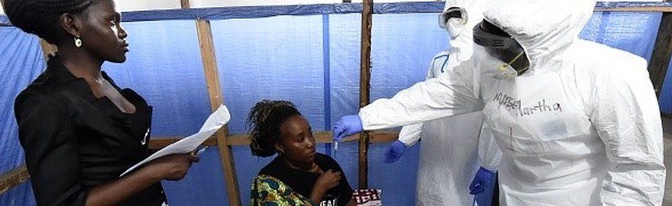 ealth workers check the temperature of person acting as a patient at a World Health Organization health center during a training session for the Ebola virus in the Liberian capital Monrovia, on October 3, 2014