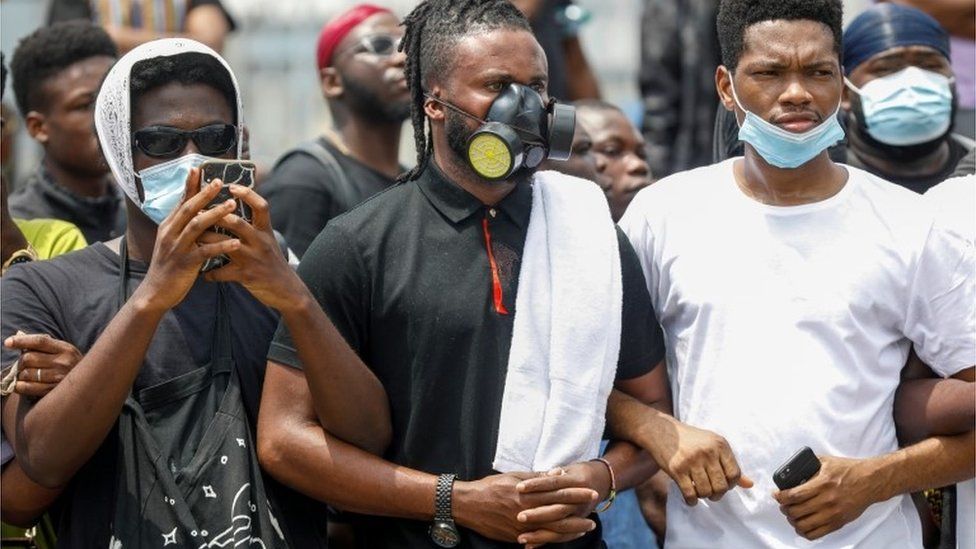 Demonstrators wearing protective masks take part in a protest over alleged police brutality, in Lagos, Nigeria October 12, 2020