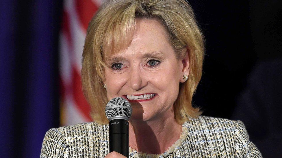 Cindy Hyde-Smith holds a microphone