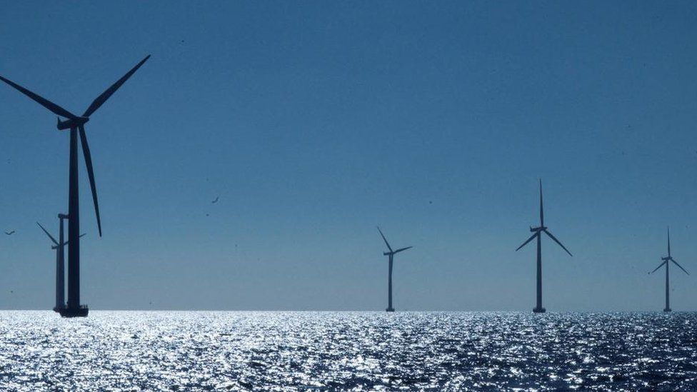 Four wind turbines at sea