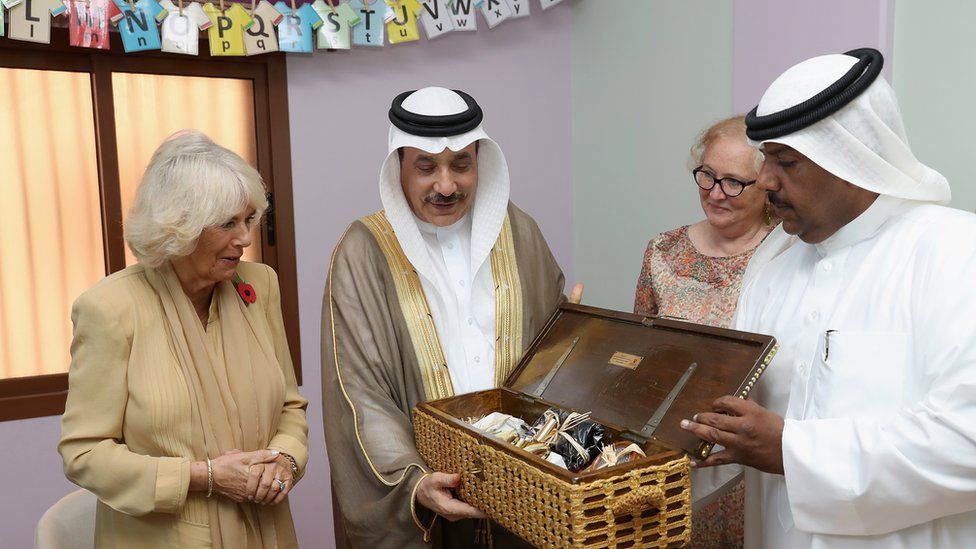 Camilla is presented with a box of traditional items manufactured by women from the refuge