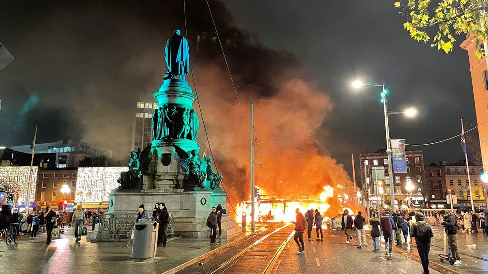 A bus and car on fire on O'Connell Street in Dublin city centre after violent scenes