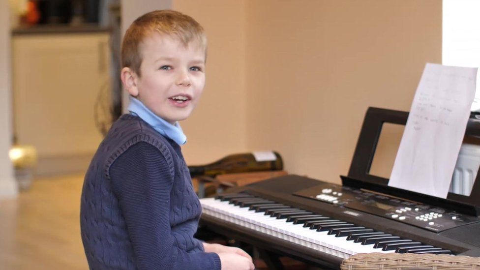 Henry completing school work from home