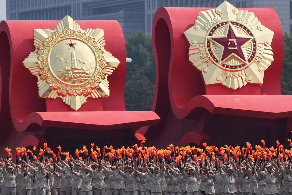 A float with an emblem of the Chinese People's Liberation Army (R) passes through Tiananmen Square during the National Day parade in Beijing on 1 October 2019, to mark the 70th anniversary of the founding of the Peoples Republic of China.