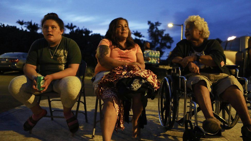 Evacuees (L to R) Anastasia de Sousa, Nina Bermasina and Aunty Willy Kamalamalama de Sousa sit outside the emergency shelter where they are staying at the Pahoa Community Center on Hawaii"s Big Island on May 5, 2018 in Pahoa, Hawaii.