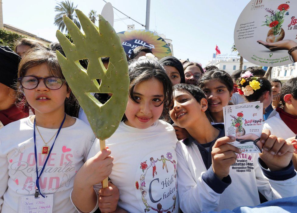 Tunisian children holding flowers at an event called "Flowers Walk" in Tunis, the capital of Tunisia.
