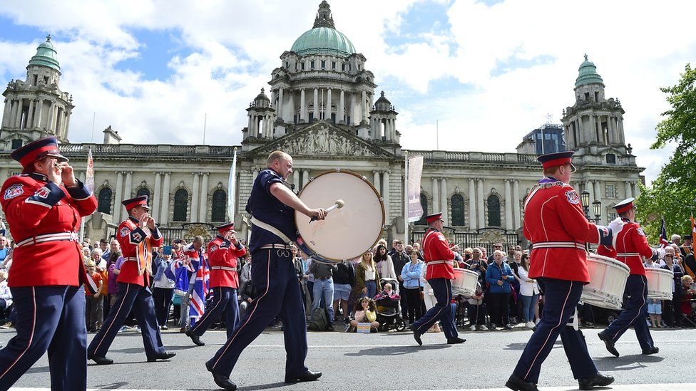 Bands pass by Belfast City Hall