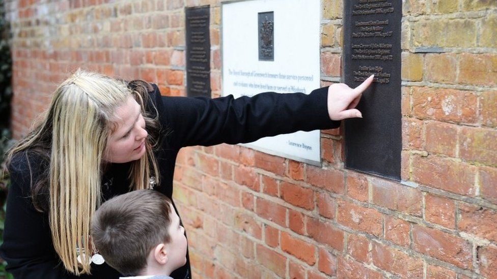 Rebecca Rigby, the widow of murdered Fusilier Lee Rigby, and son Jack looking at a memorial in his memory