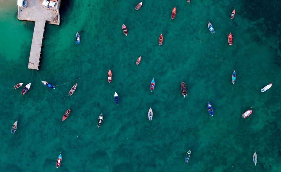 An aerial view of fisher boats in the ocean