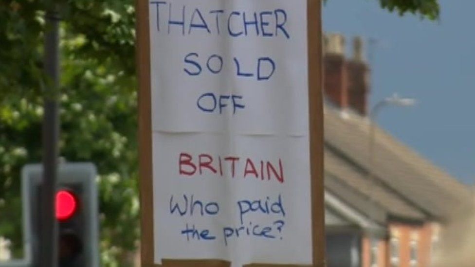 Person holding a placard