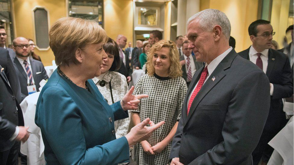 A handout photo made available by the press office of the German government (BPA) shows German Chancellor Angela Merkel (L) and US Vice President Michael Pence (R) having a chat during the 53rd Munich Security Conference