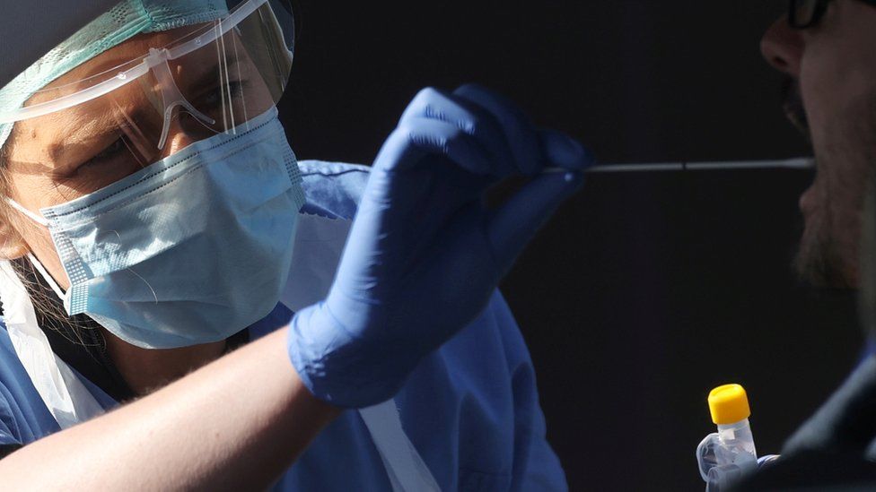 A nurse giving swab test