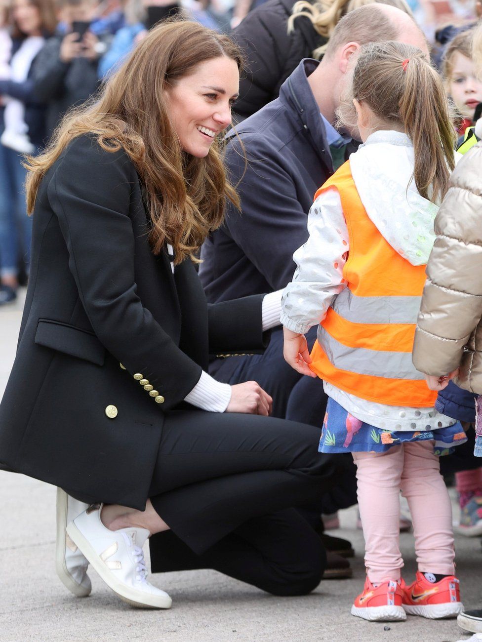 William and Kate speak to young children as they visited local fishermen and their families