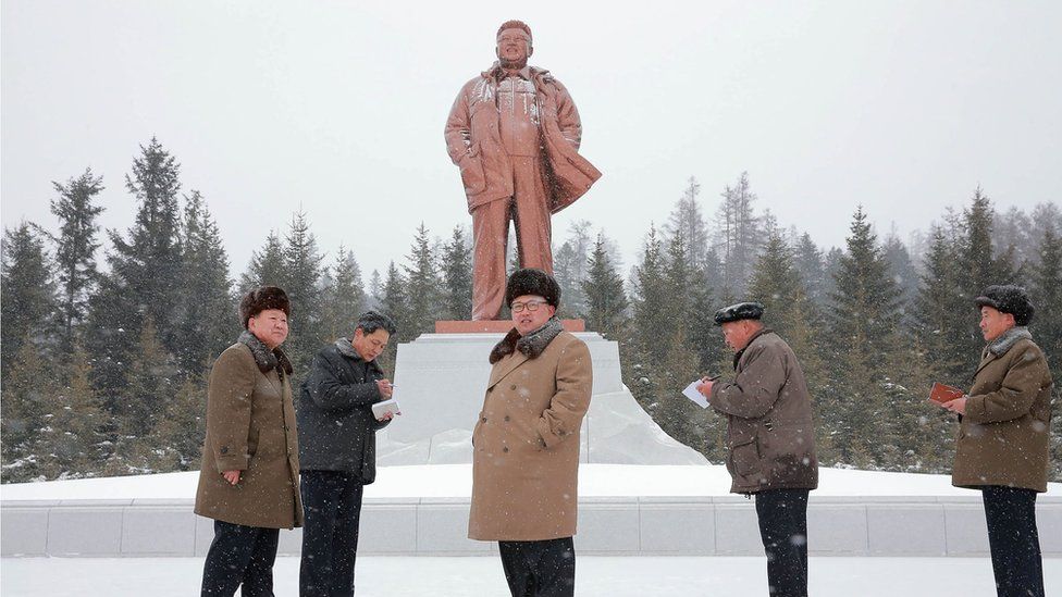 This undated picture released by North Korea"s official Korean Central News Agency (KCNA) on November 28, 2016 shows North Korean leader Kim Jong-Un (C) standing in front of a bronze statue of the late Kim Jong-Il in Samjiyun