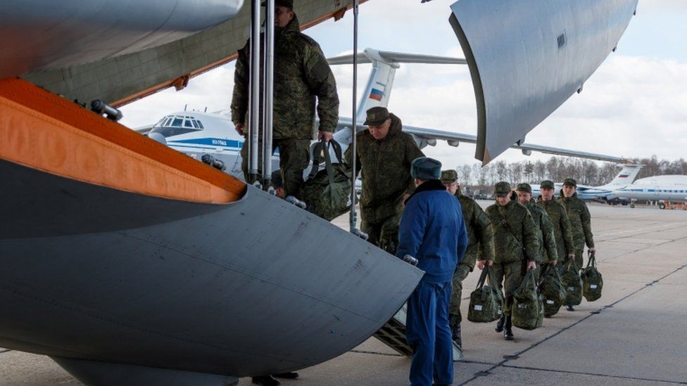 Russian defence ministry photos show army personnel boarding a flight to Italy in March
