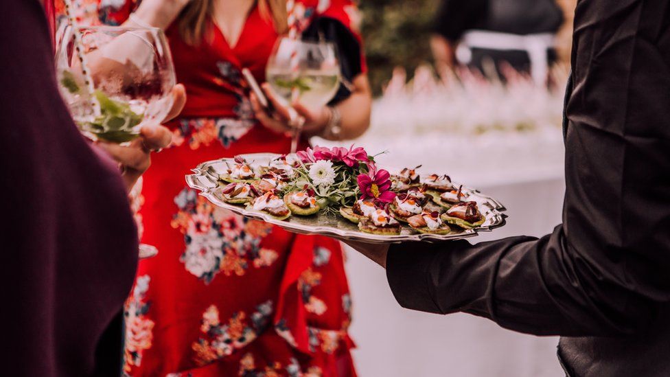 Guests at a wedding eating canapes