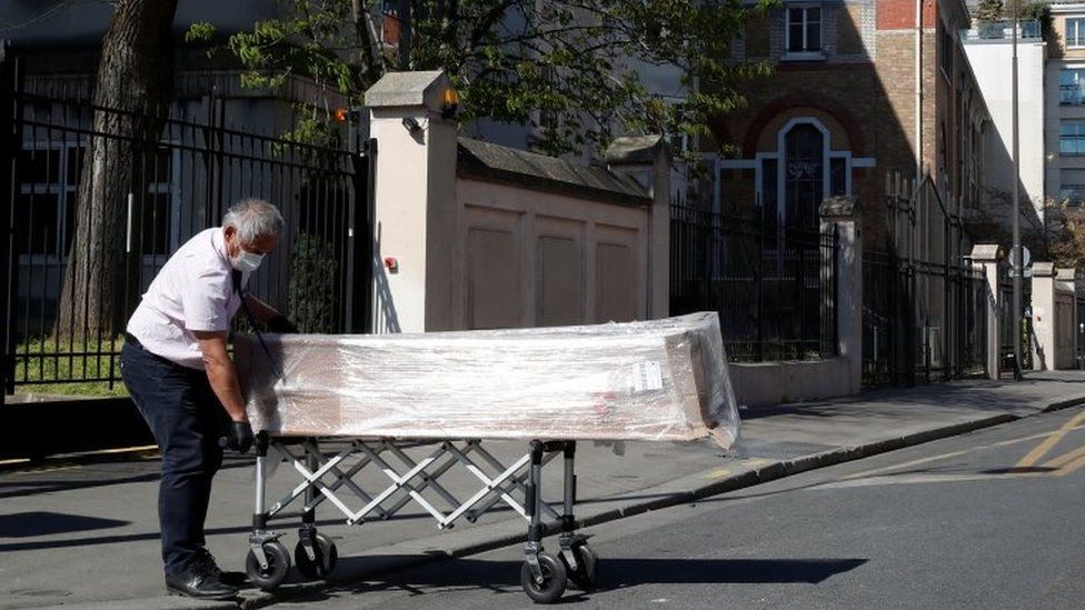 An employee delivers a coffin at the Fondation Rothschild retirement home (Ehpad) in Paris where 16 residents have died and 81 have been infected with coronavirus disease (COVID-19) as the spread of the coronavirus disease (COVID-19) continues in France, March 25, 2020