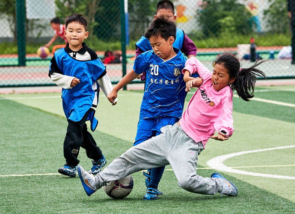 Primary school students play football at a fitness centre on April 27, 2024 in Jiaxing, Zhejiang Province of China.