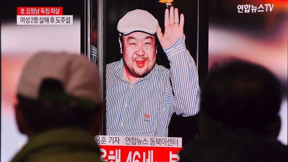 Men watch a TV screen in a train station in Seoul on 14 February 2017 showing an image of Kim Jong-nam.