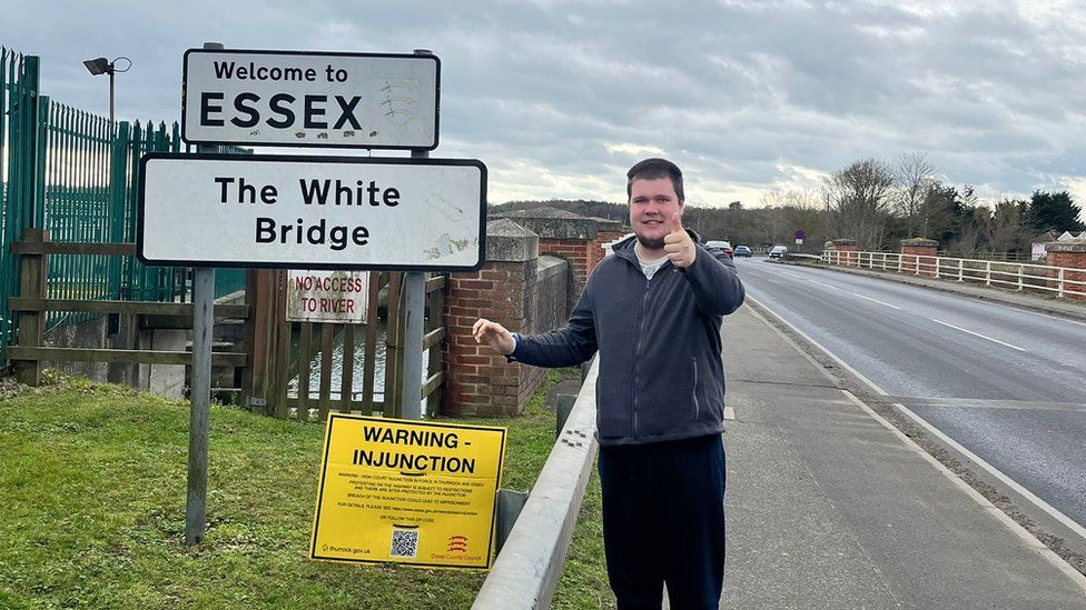 Kireon Wicks at one of the Welcome to Essex signs