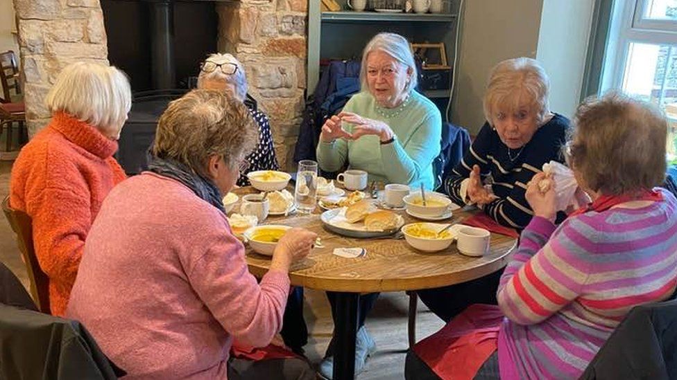 Older women enjoy a meet up at the The Rising Sun pub