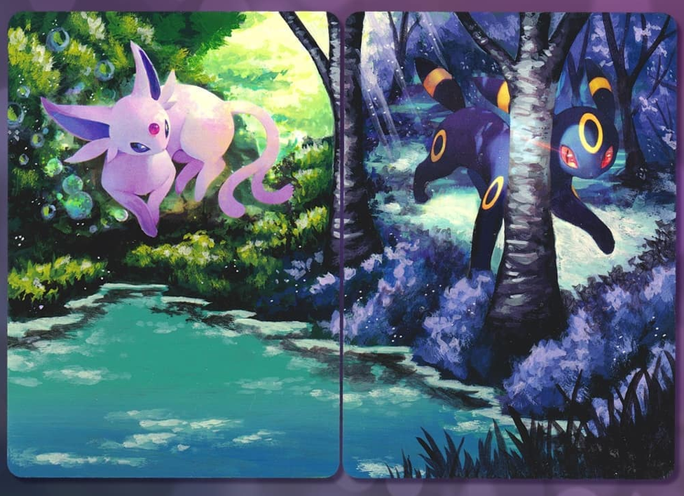 The Umbreon and Espeon cards repainted. The artwork now extends to cover the entire cards, creating a scenic day and night painting with a forest and lake.