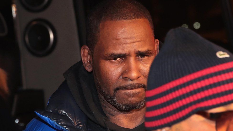 R Kelly arriving at police station to hand himself in