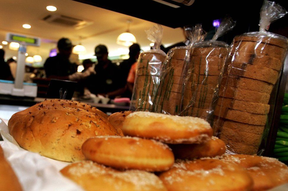 Sales assistants work in the background as breads are displayed in the newly inaugurated Gourmet outlet in Bangalore
