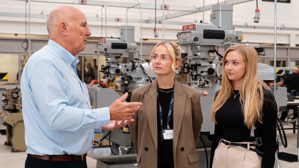 HETA business development executive Mick Wigglesworth with Holly Barker (centre) and Zoe Pell of EFAB in the mechanical engineering workshop