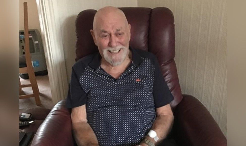 A male pensioner sitting in an armchair