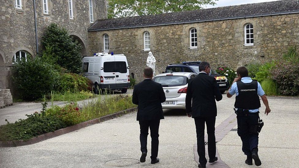 French police walk where a French catholic priest was killed in Saint-Laurent-sur-Sevres