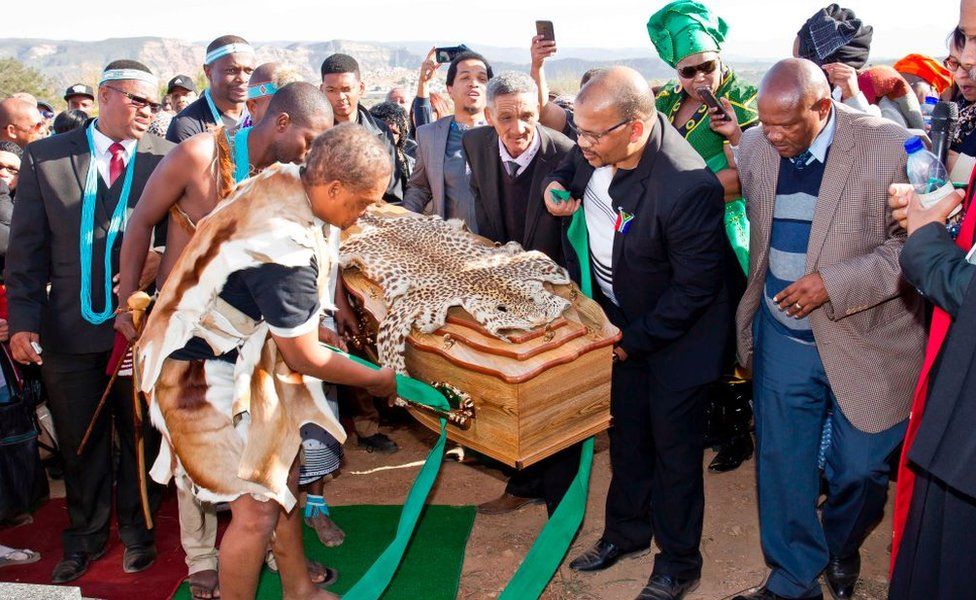 People carry the coffin as Khoi activists, Khoi San community members, relatives and government officials attend the symbolic burial ceremony of Khoisan Traditional leader and freedom fighter David Stuurman on June 16, 2017 i