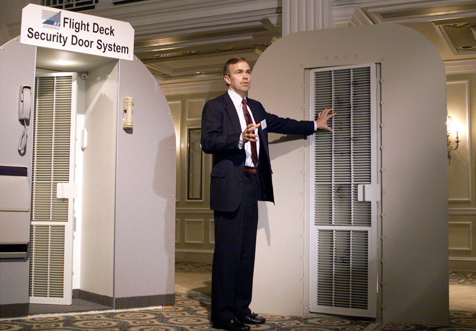Scott Smith of B/E Aerospace Inc. shows the new AeroGuard cockpit security system featuring an anti-ballistic cockpit door with a patent-pending locking system that survives against handguns, automatic weapons and brute force assault October 29, 2001 in Washington, DC