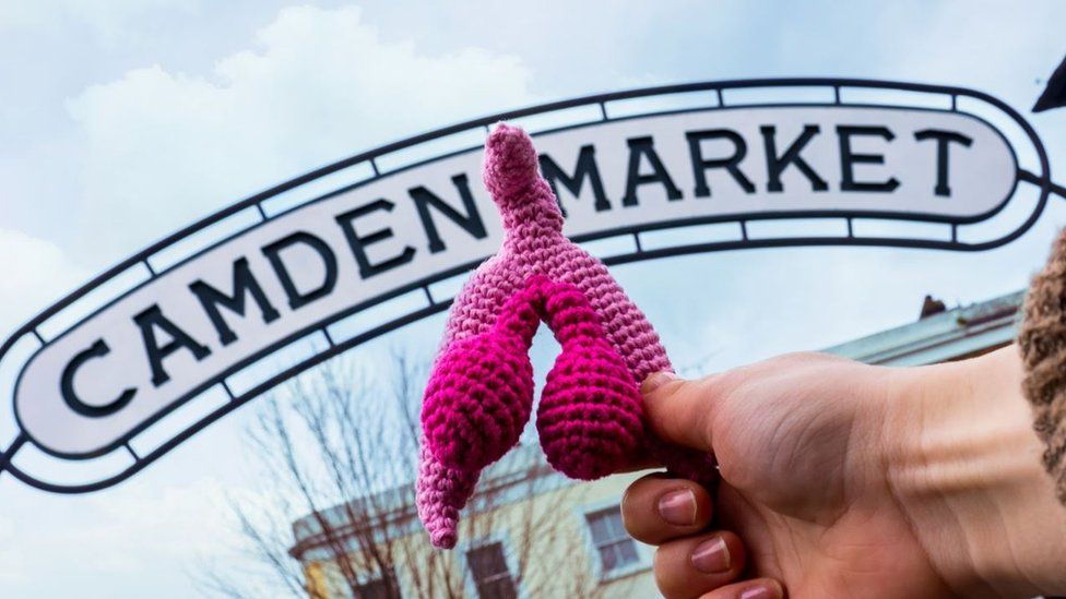 A pink wool crochet reproduction of the clitoris